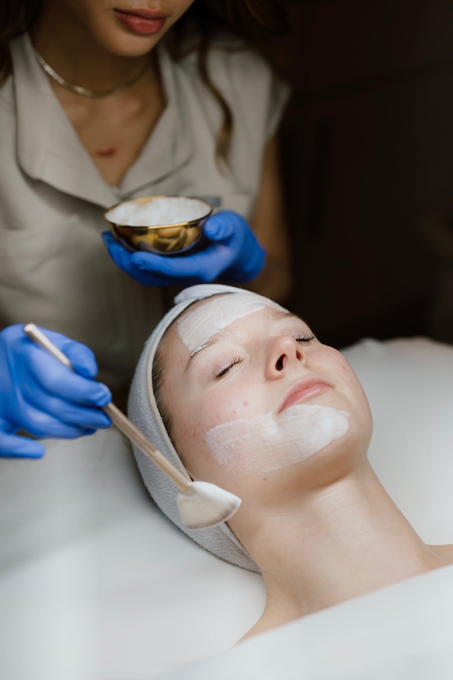 Vivianna painting on facial cream on client with a fan brush