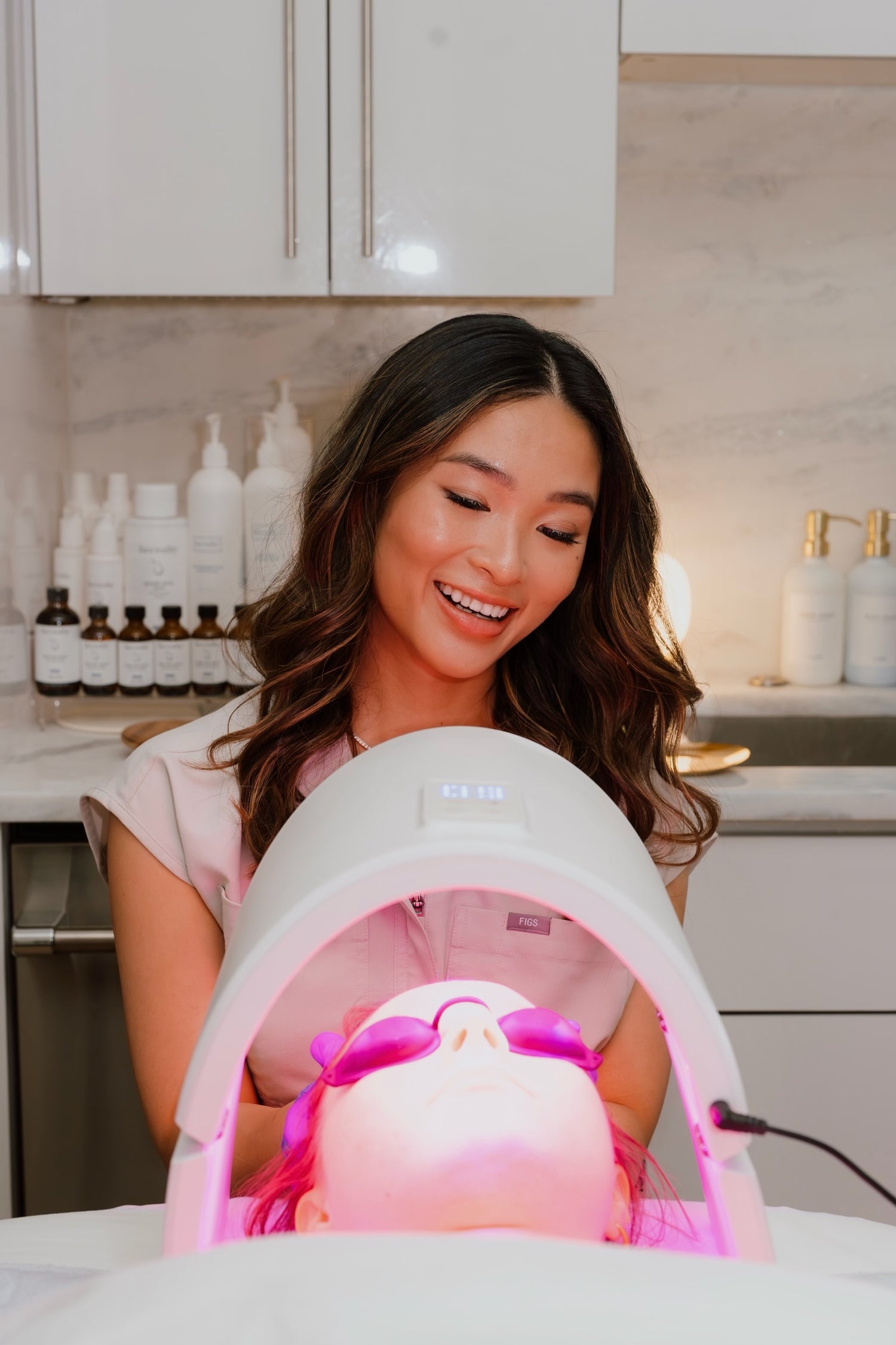 Viviana setting up client with a red light treatment. 