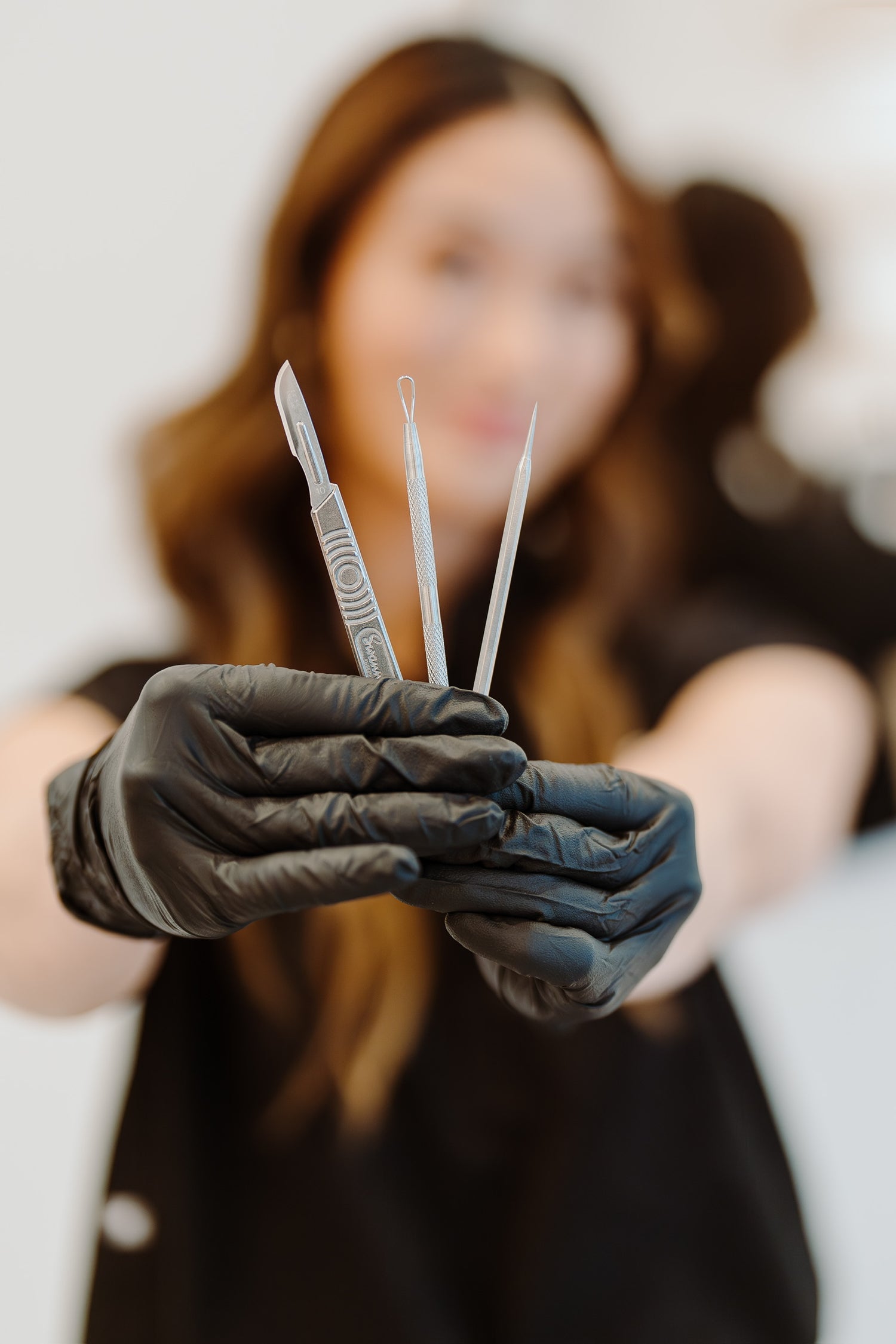 Viviana holding extraction tools for facials.